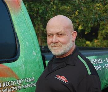 male crew chief standing in front of truck