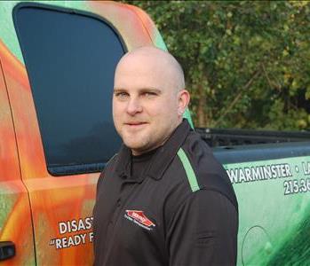 male crew chief standing in front of truck