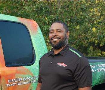 male crew chief standing in front of truck