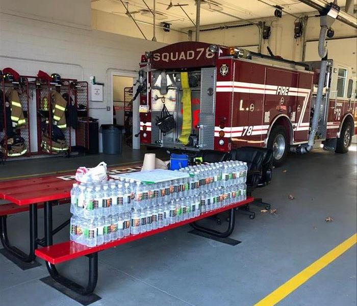 Servpro water cases in front of fire engine