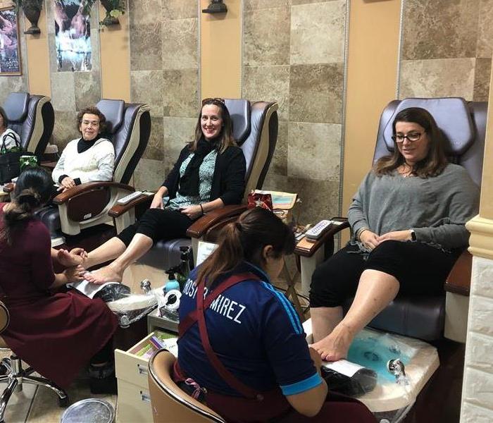 Women sitting in pedicure chairs