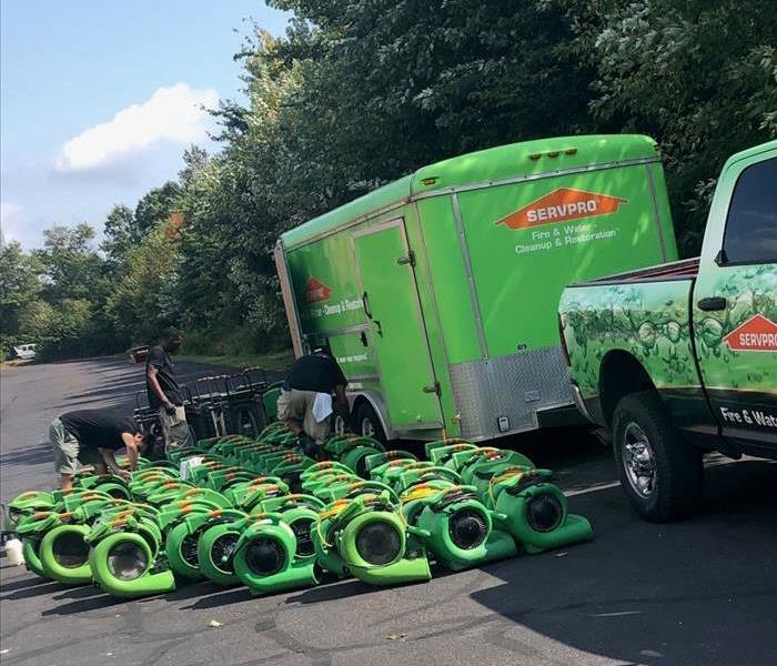 Truck and trailer with many fans sitting outside